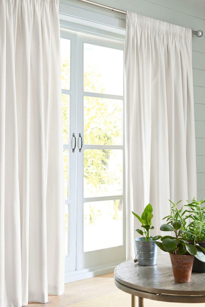 A Living Room With White Curtains And Potted Plants On A Table — Mid Coast Flooring & Blinds In Laurieton, NSW