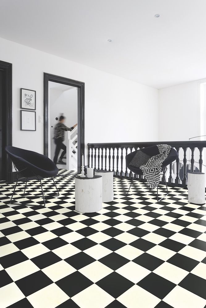 A Black And White Checkered Floor In A Living Room With Chairs And Tables — Mid Coast Flooring & Blinds In Taree, NSW