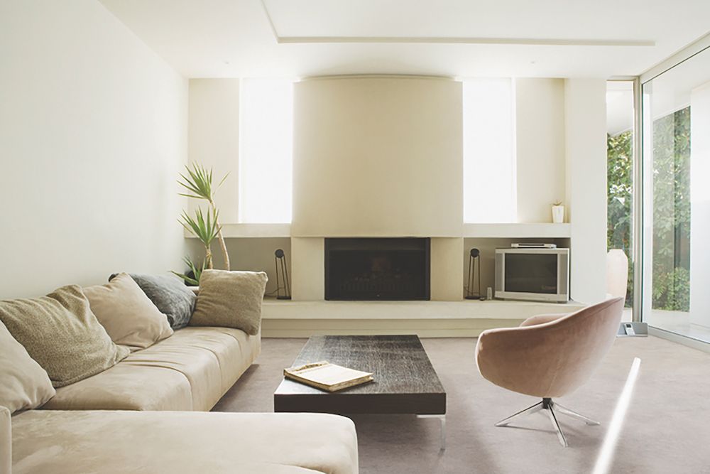 A Living Room With A Couch A Chair A Table And A Fireplace — Mid Coast Flooring & Blinds In Forster, NSW