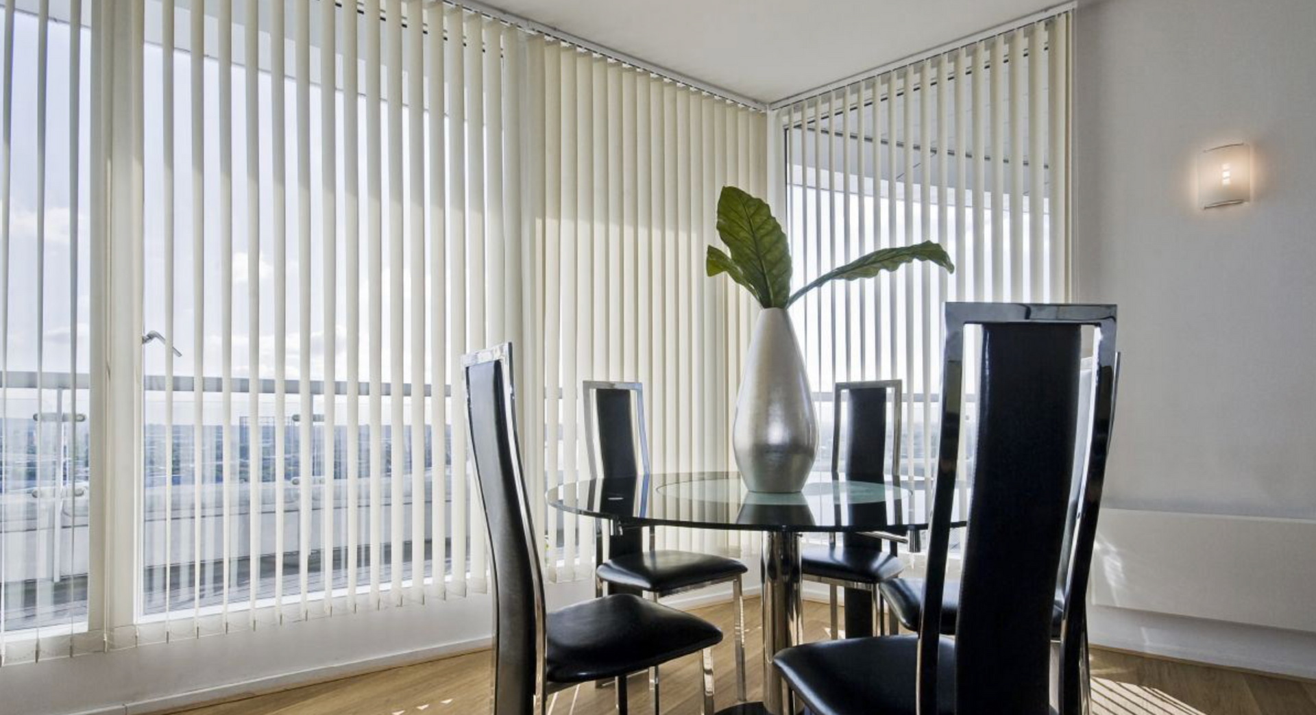 A Potted Plant Is Sitting On A Gray Floor Next To A Dresser — Mid Coast Flooring & Blinds In Harrington, NSW