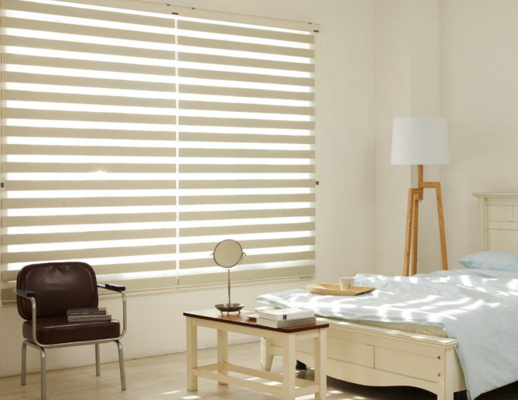 A Bedroom with A Bed, Chair, Table and Mirror — Mid Coast Flooring & Blinds In Forster, NSW
