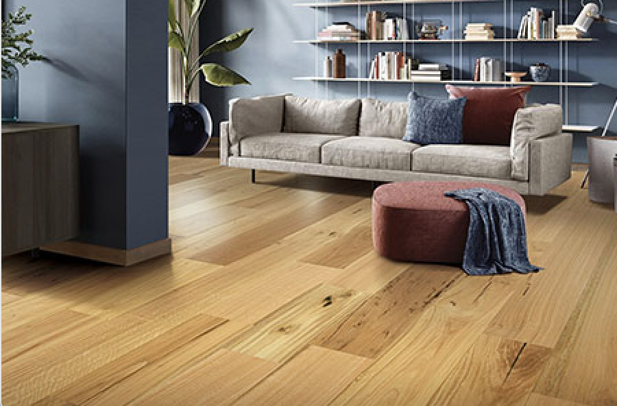 A Living Room With A Couch And A Coffee Table On A Wooden Floor — Mid Coast Flooring & Blinds In Harrington, NSW