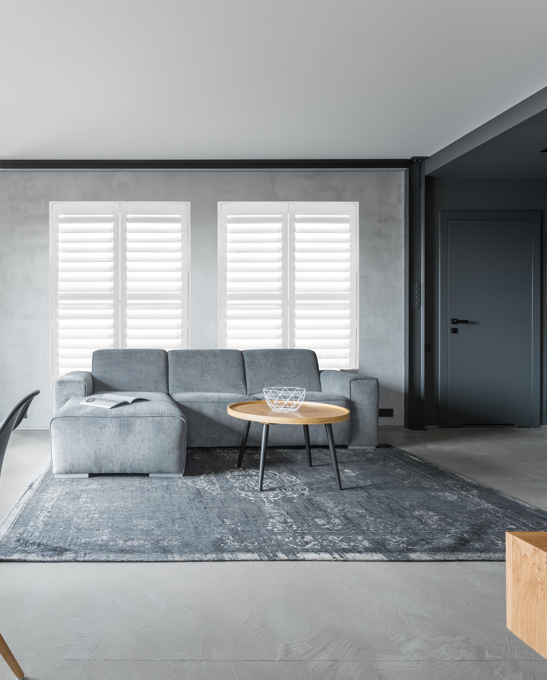 A living room with a couch , table and rug — Mid Coast Flooring & Blinds In Taree, NSW