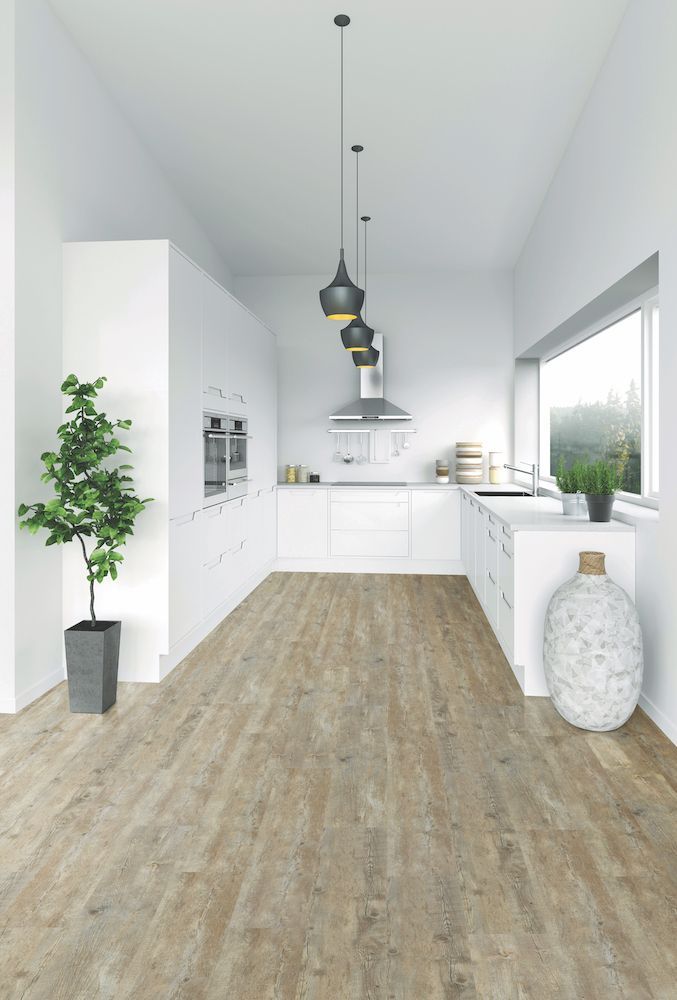 A Kitchen With A Wooden Floor And White Cabinets — Mid Coast Flooring & Blinds In Taree, NSW