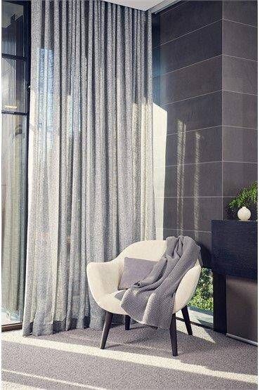 A Chair With A Book On It Is Sitting In Front Of A Window — Mid Coast Flooring & Blinds In Forster, NSW