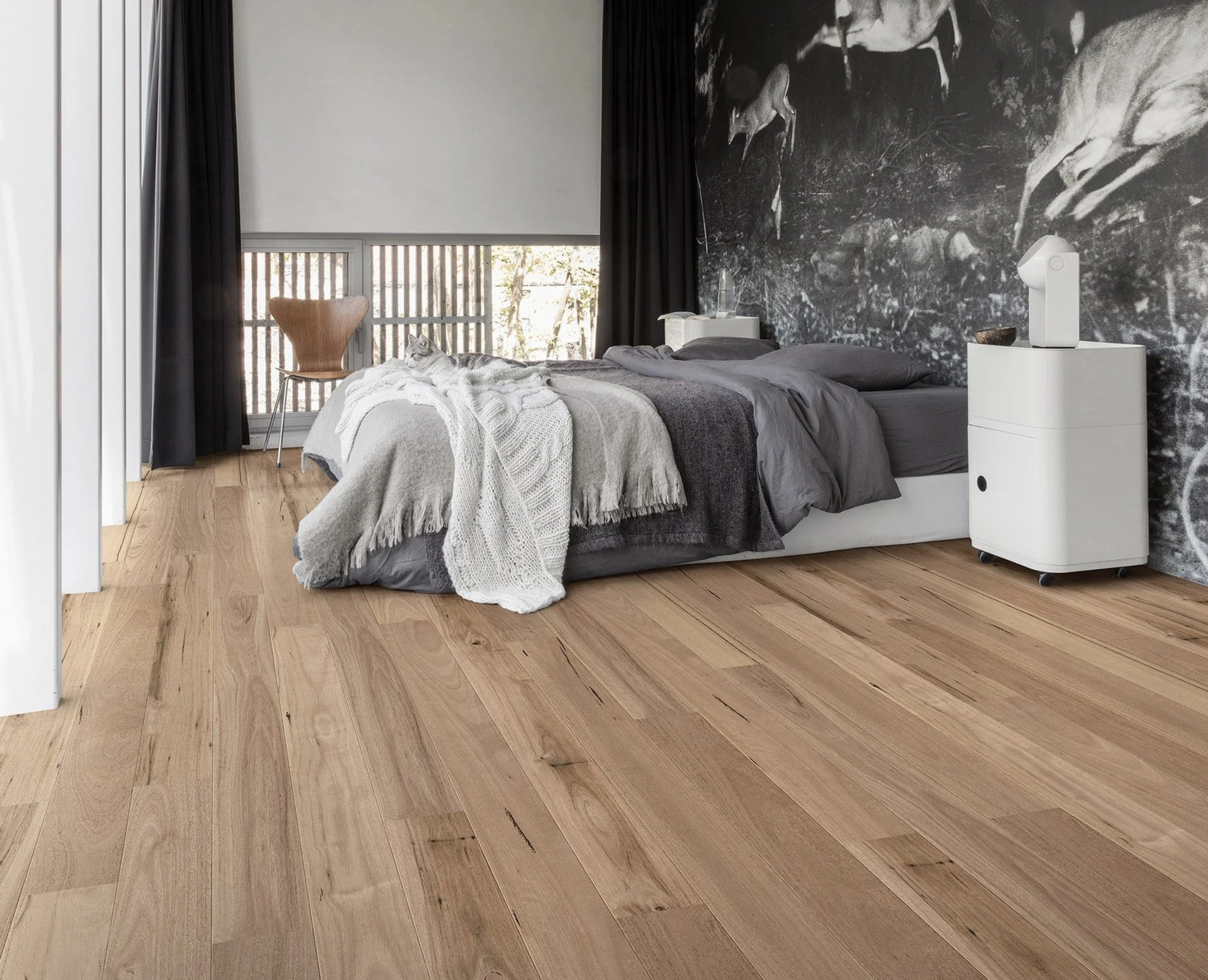 A Bedroom With Hardwood Floors And A Bed — Mid Coast Flooring & Blinds In Taree, NSW