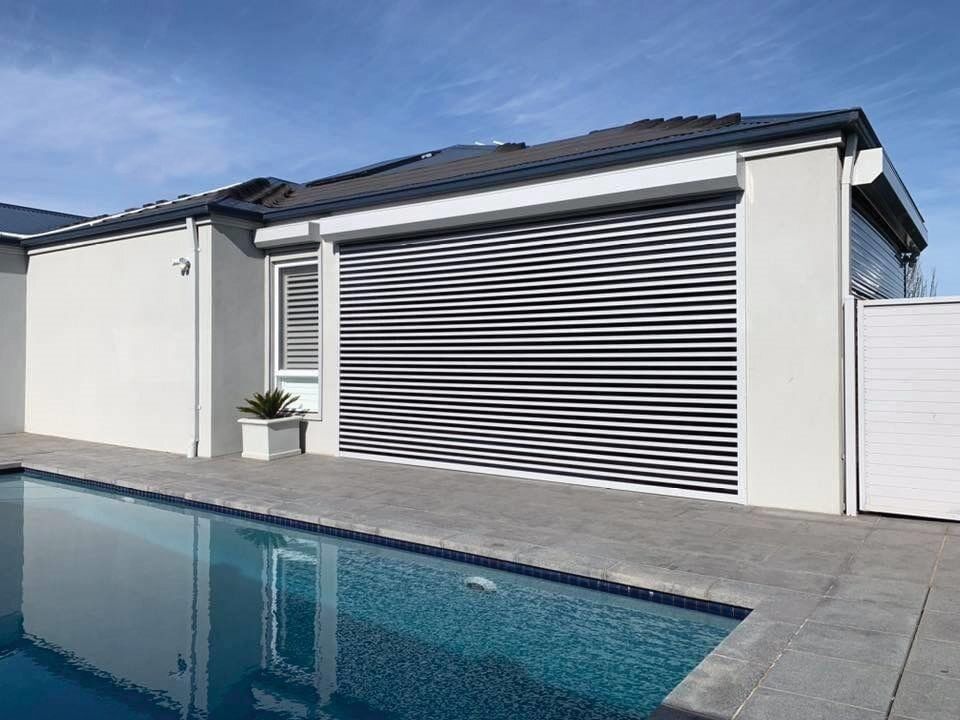 A House With A Swimming Pool In Front Of It — Mid Coast Flooring & Blinds In Taree, NSW