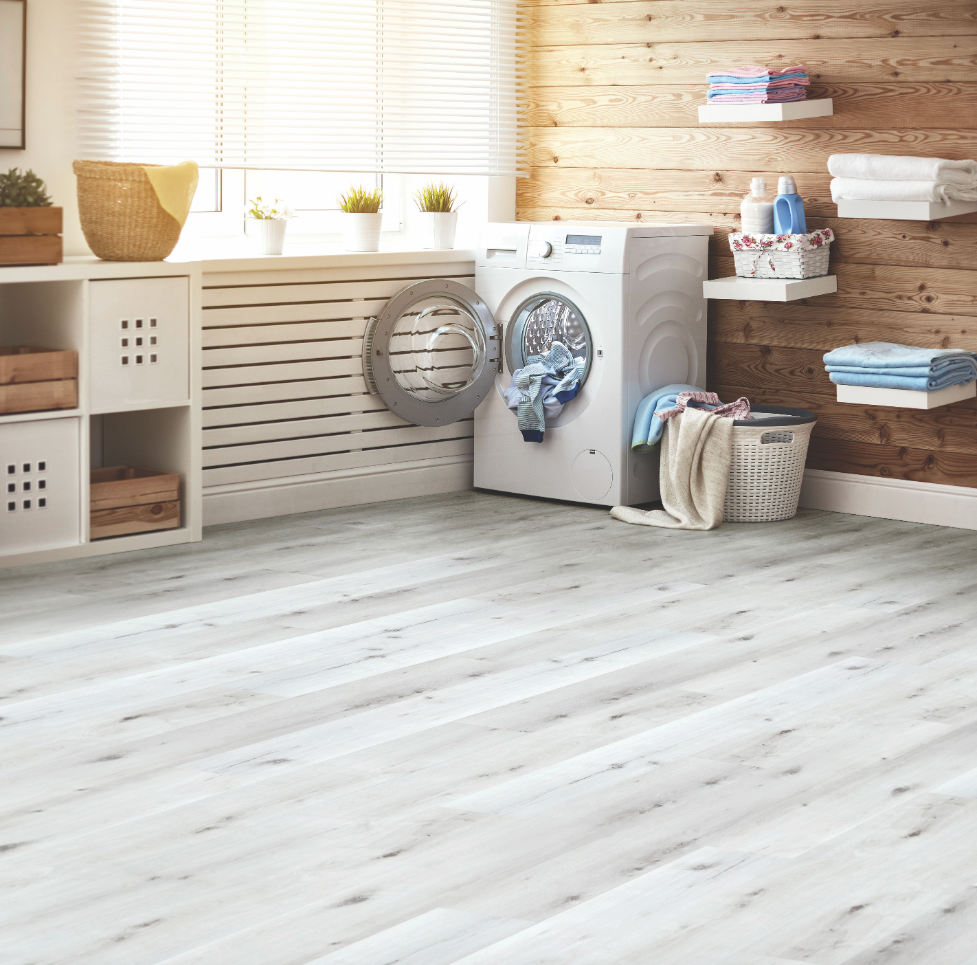 A Man Is Kneeling Down While Installing A Vinyl Floor — Mid Coast Flooring & Blinds In Harrington, NSW