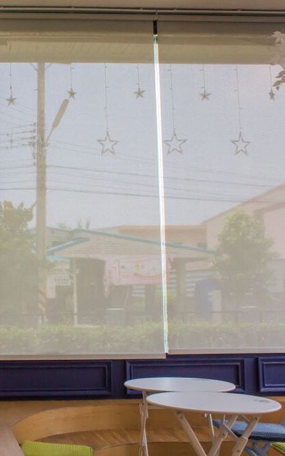 A Room With Tables And Chairs And A Window With A Blind On It — Mid Coast Flooring & Blinds In Forster, NSW