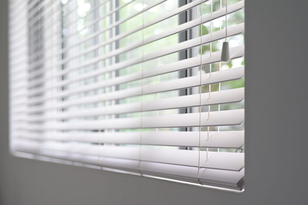 A Close Up Of A Window With Blinds On It — Mid Coast Flooring & Blinds In Forster, NSW