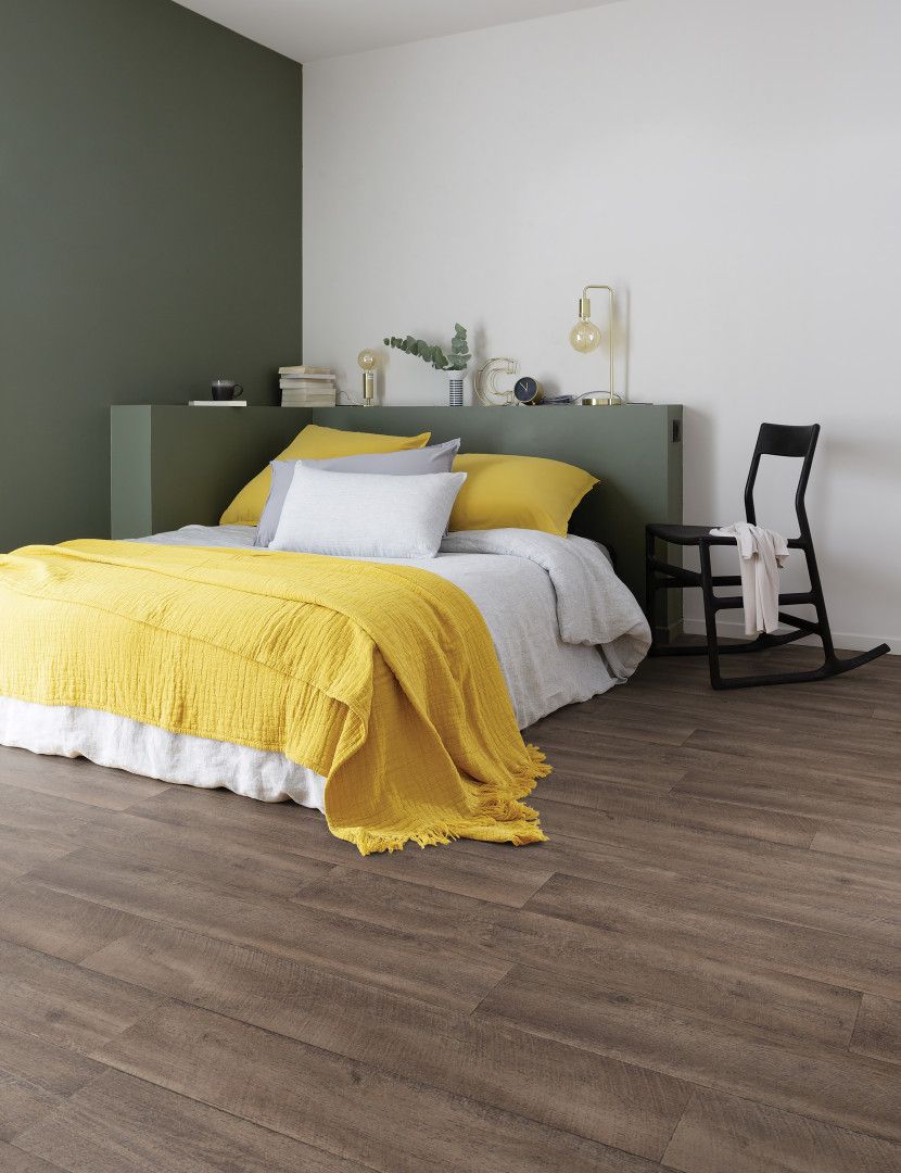 A Bed Is Sitting In A Bedroom Next To A Window — Mid Coast Flooring & Blinds In Forster, NSW