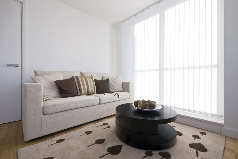 A Living Room With A Couch And A Coffee Table — Mid Coast Flooring & Blinds In Taree, NSW