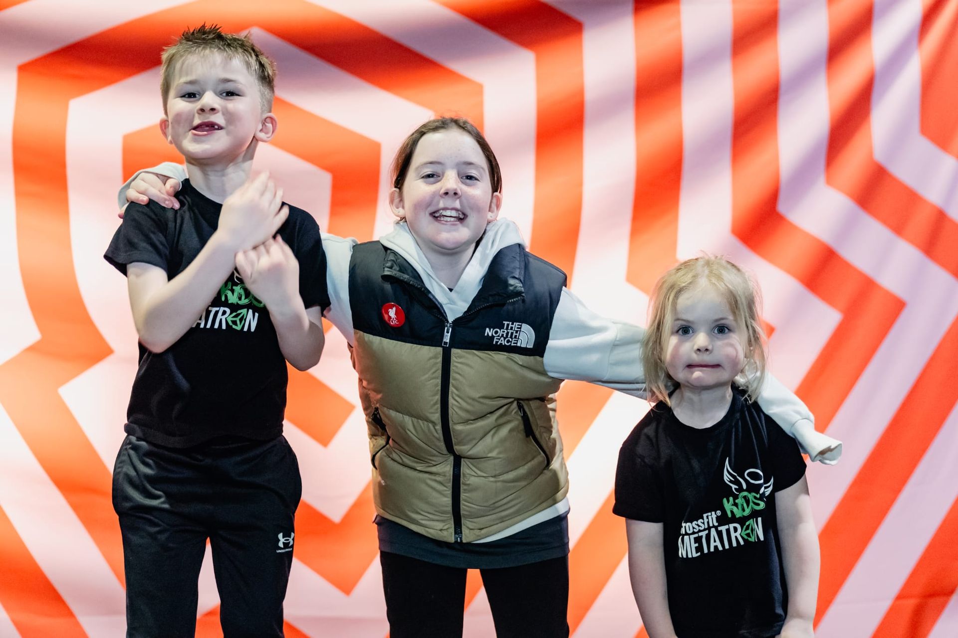 A young girl is using a rowing machine on a field