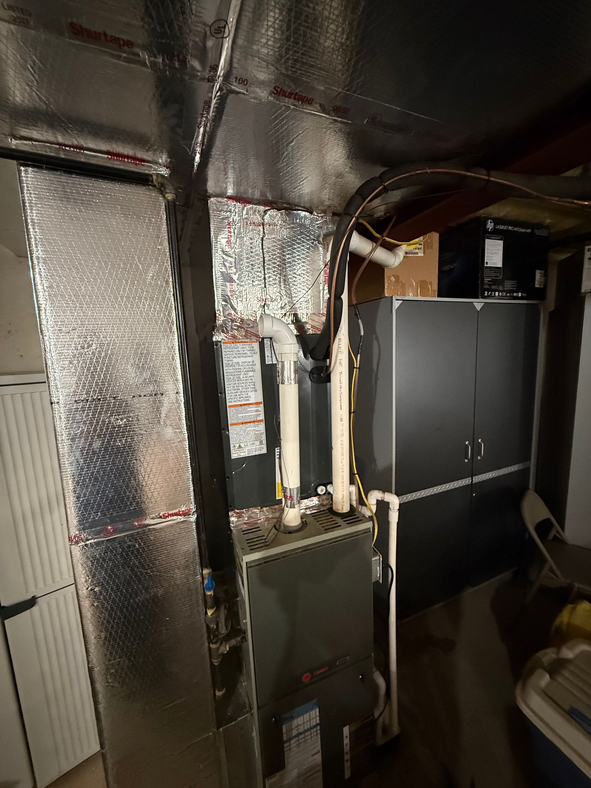 A room with a furnace and a heater in it.