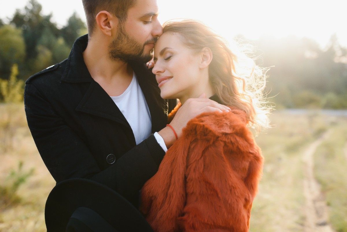 couples standing in sunlight