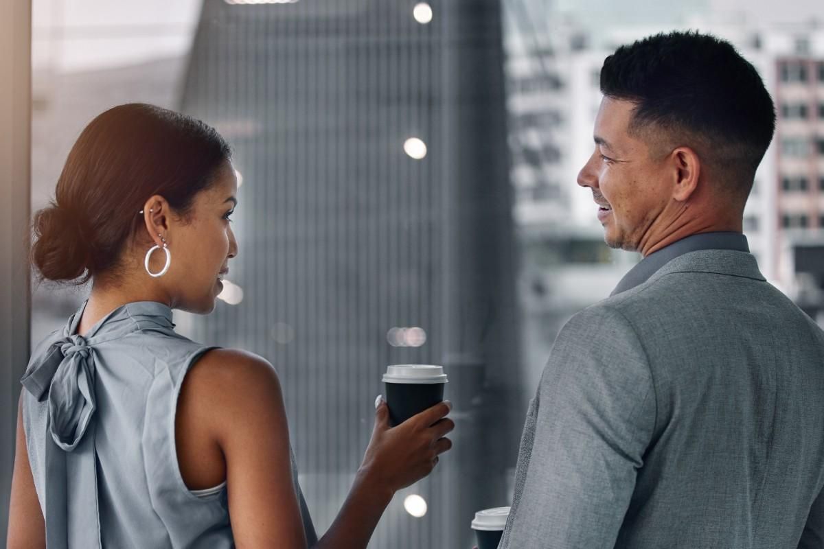 couples talking to each other holding a cup