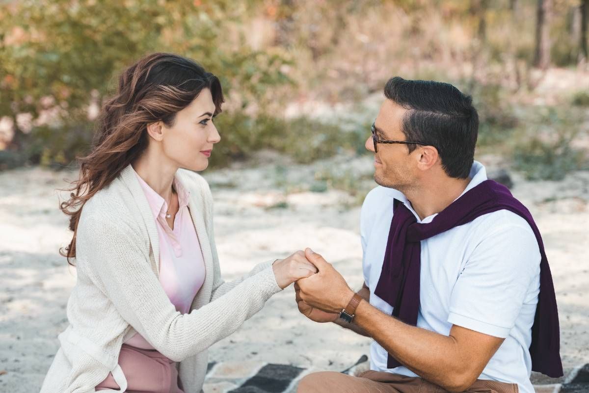 couples looking each other holing hands