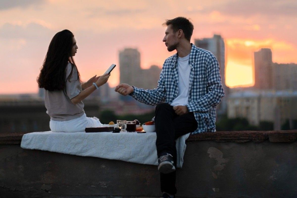 couple sitting and talking to each other in evening 