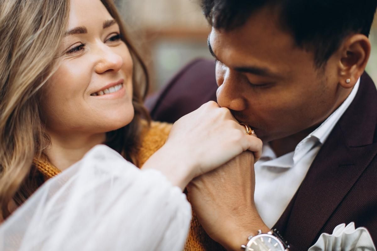 man kissing girl hand