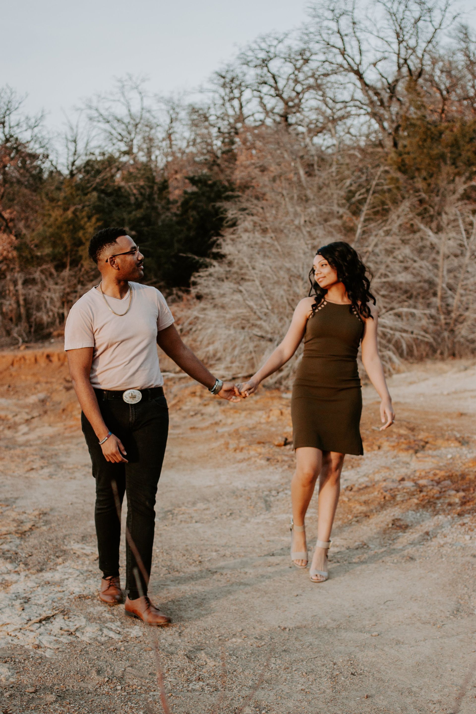 Man and woman holding hands and exchanging a loving look, highlighting emotional connection from luxury matchmaking.