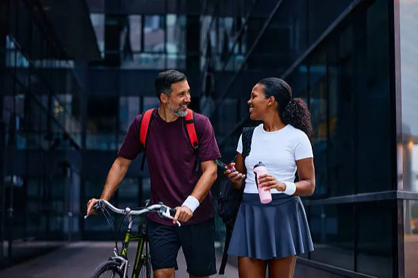 couples walking with holding a cycle