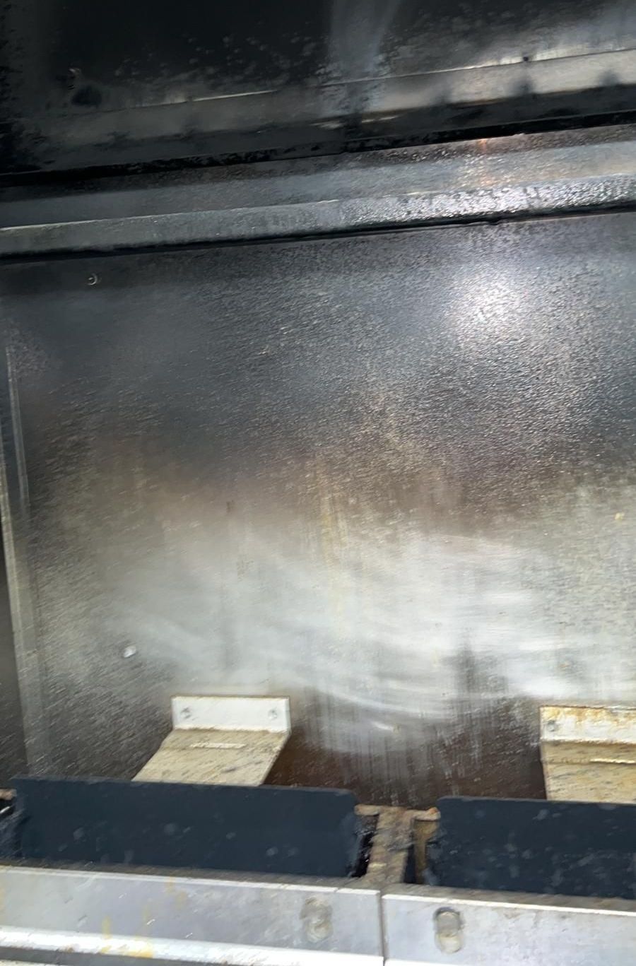 a close up of a dirty stove with a lot of smoke coming out of it .