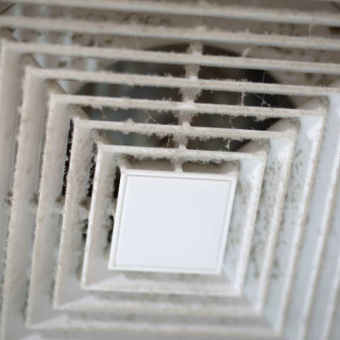 a close up of a dirty air vent on the ceiling