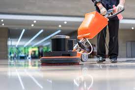 a person is cleaning a floor with a machine 