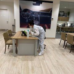 a woman is cleaning a desk in a car dealership .