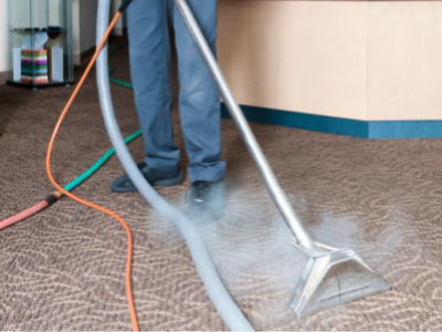 a person is using a vacuum cleaner to clean a carpet