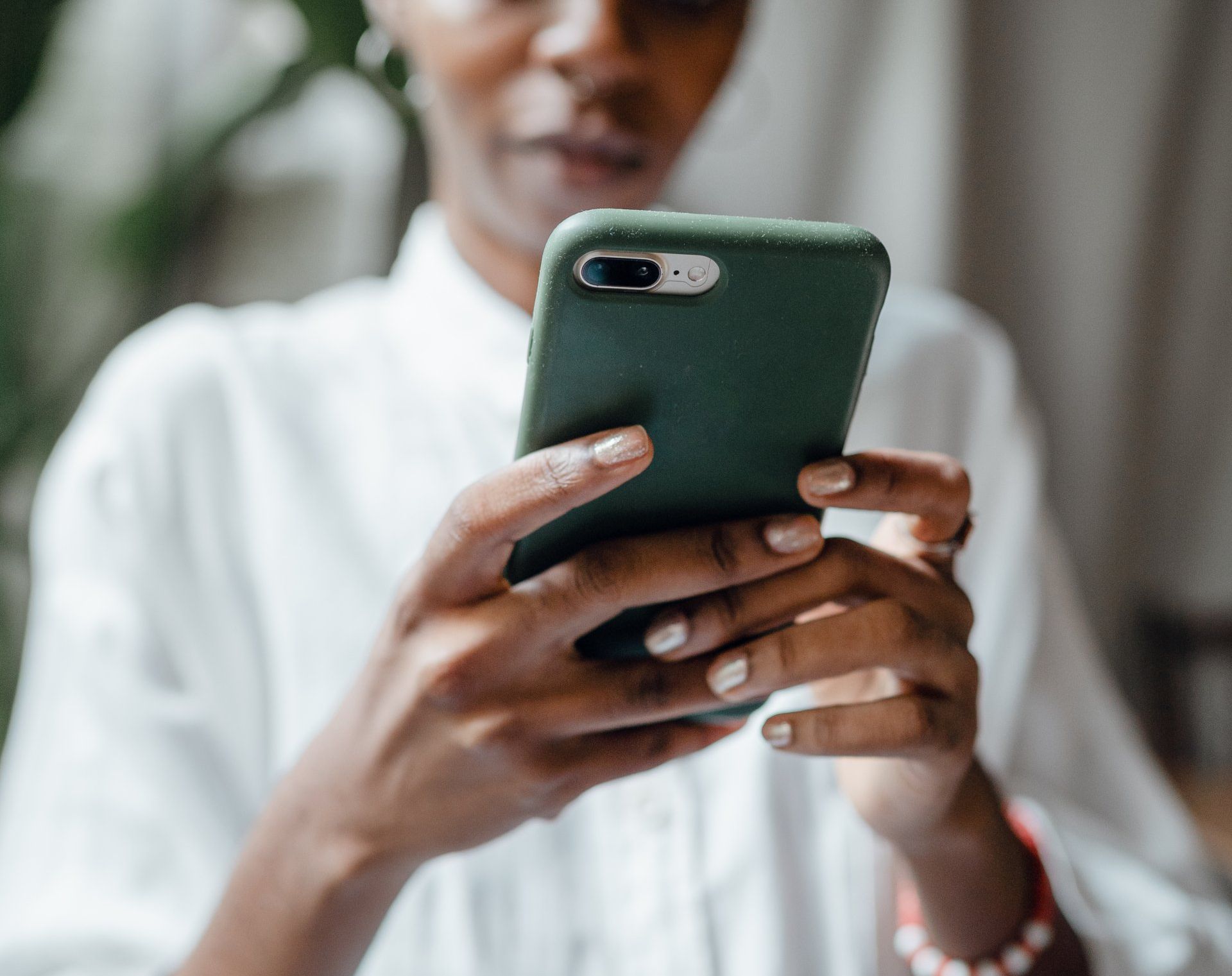 woman on green smartphone