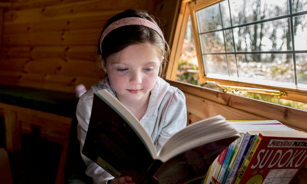 girl reading book inside a bbq hut