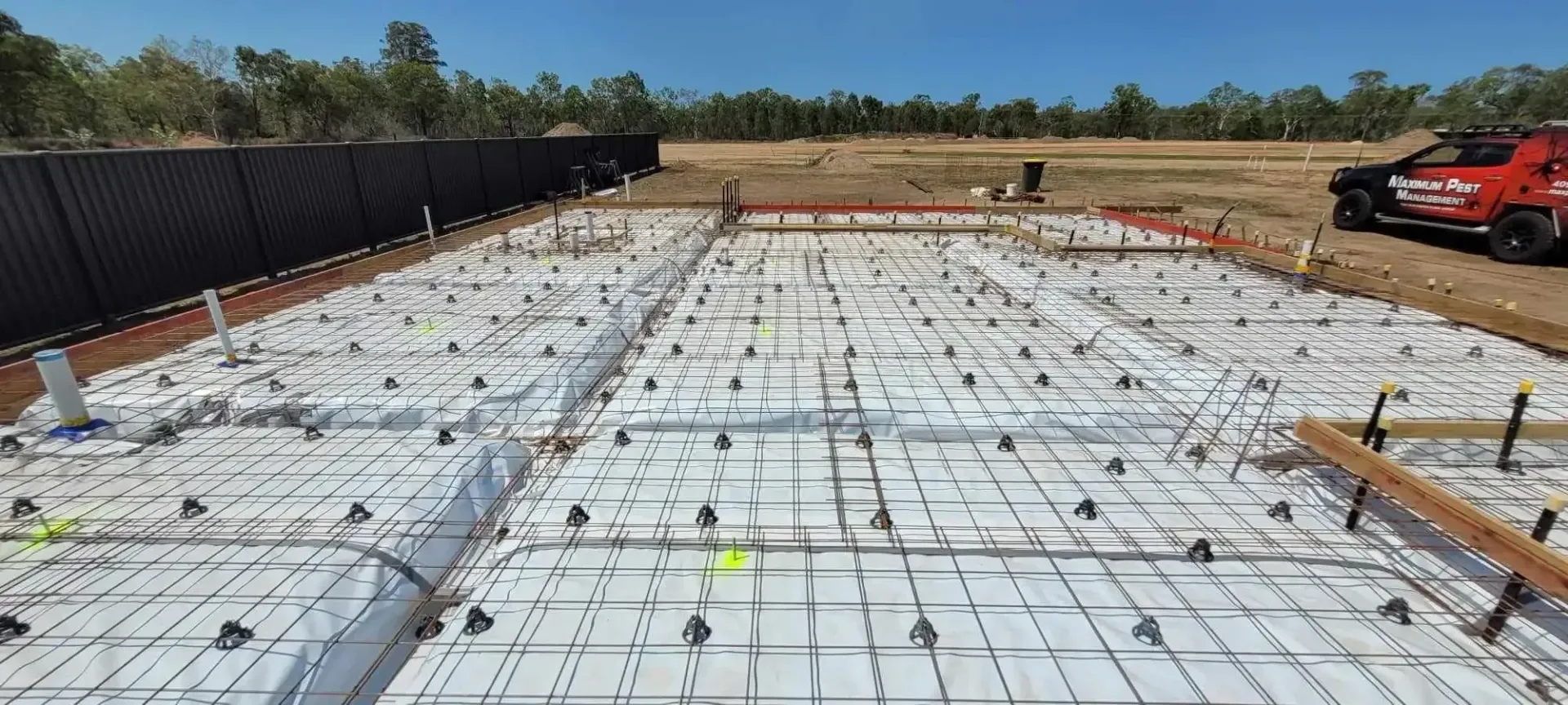 A construction site with a Truck parked in the background — Maximum Pest Management In Mareeba, QLD