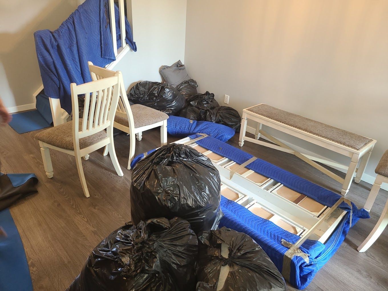 A man and a woman are leaning on a pile of cardboard boxes.