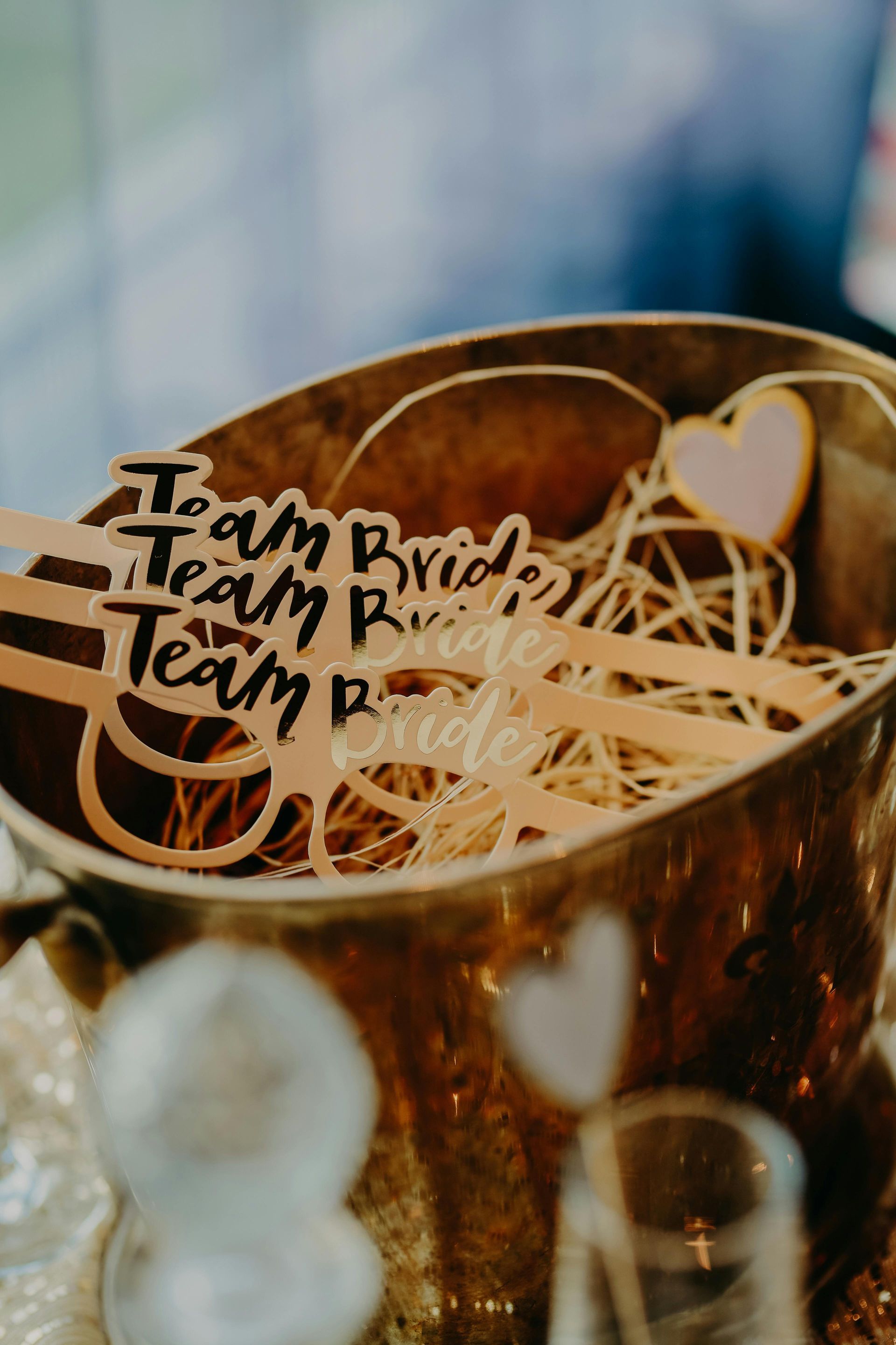 A bucket filled with wooden spoons with the words `` i am team bride '' written on them.
