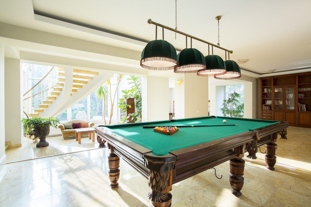 Pool Table In The Middle Of The Room With Green Pendant Lights — Eight Ball Services In Taranganba, QLD