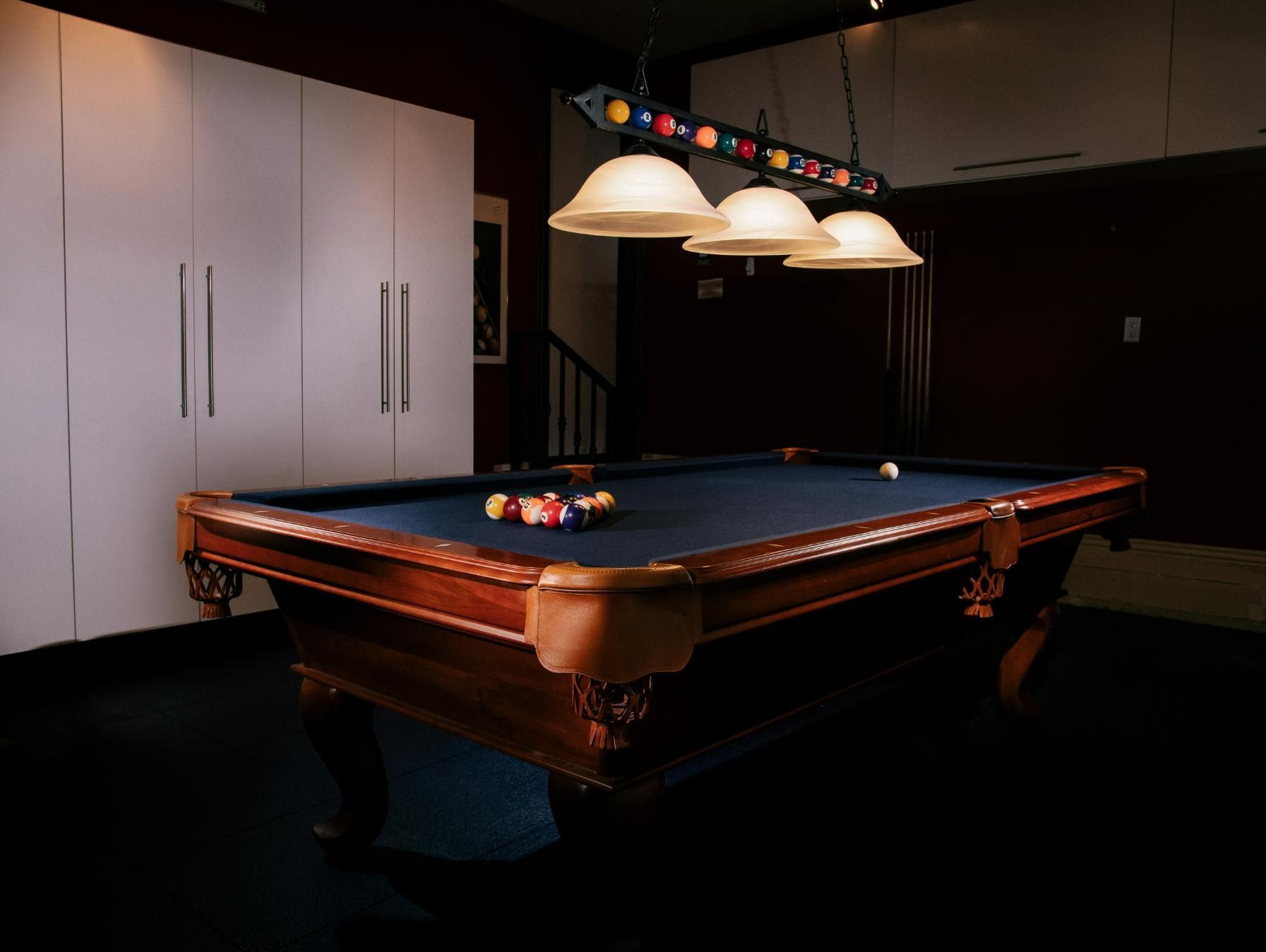Pool Table In A Room With Three Lights Hanging From The Ceiling — Eight Ball Services In Taranganba, QLD