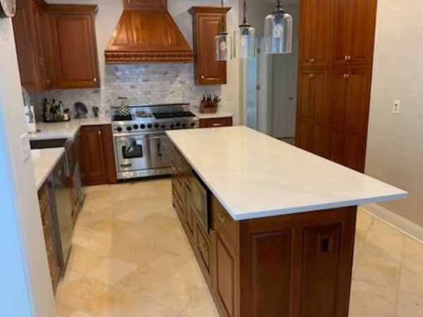 A kitchen with a large island in the middle of it.