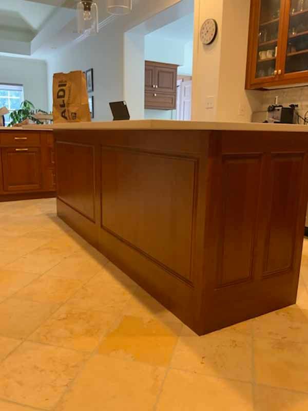 A kitchen with wooden cabinets and a bag that says aldi on it