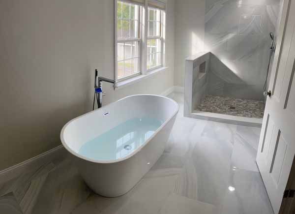 A bathroom with a bathtub and a walk in shower.