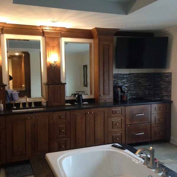 A bathroom with a bathtub and two mirrors