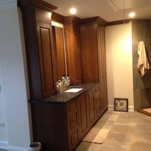 A bathroom with wooden cabinets and a sink