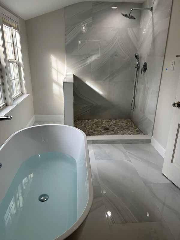 A bathroom with a bathtub and a walk in shower.
