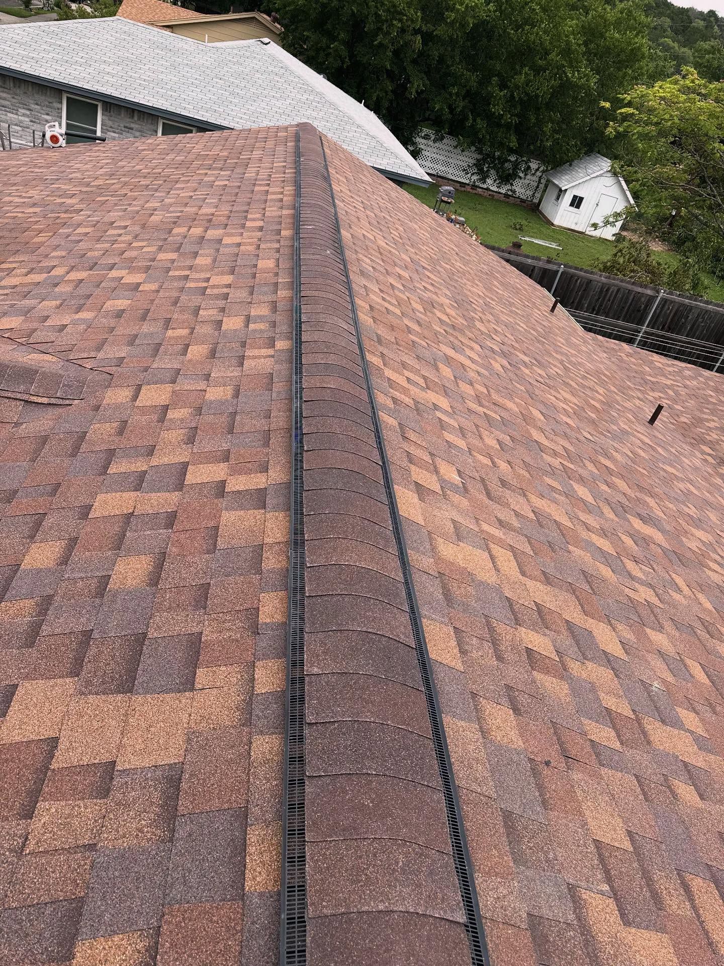 A close up of a roof with a drain on it.