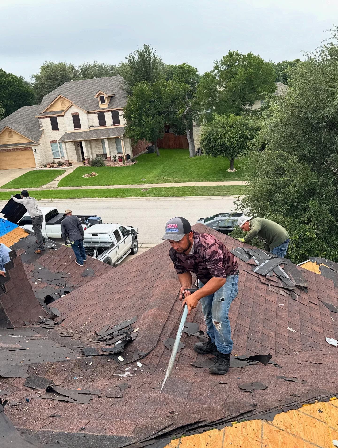 A man is working on the roof of a house.