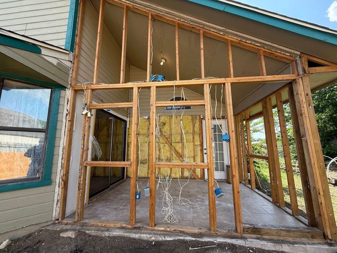 A house is being remodeled with wooden frames and insulation.