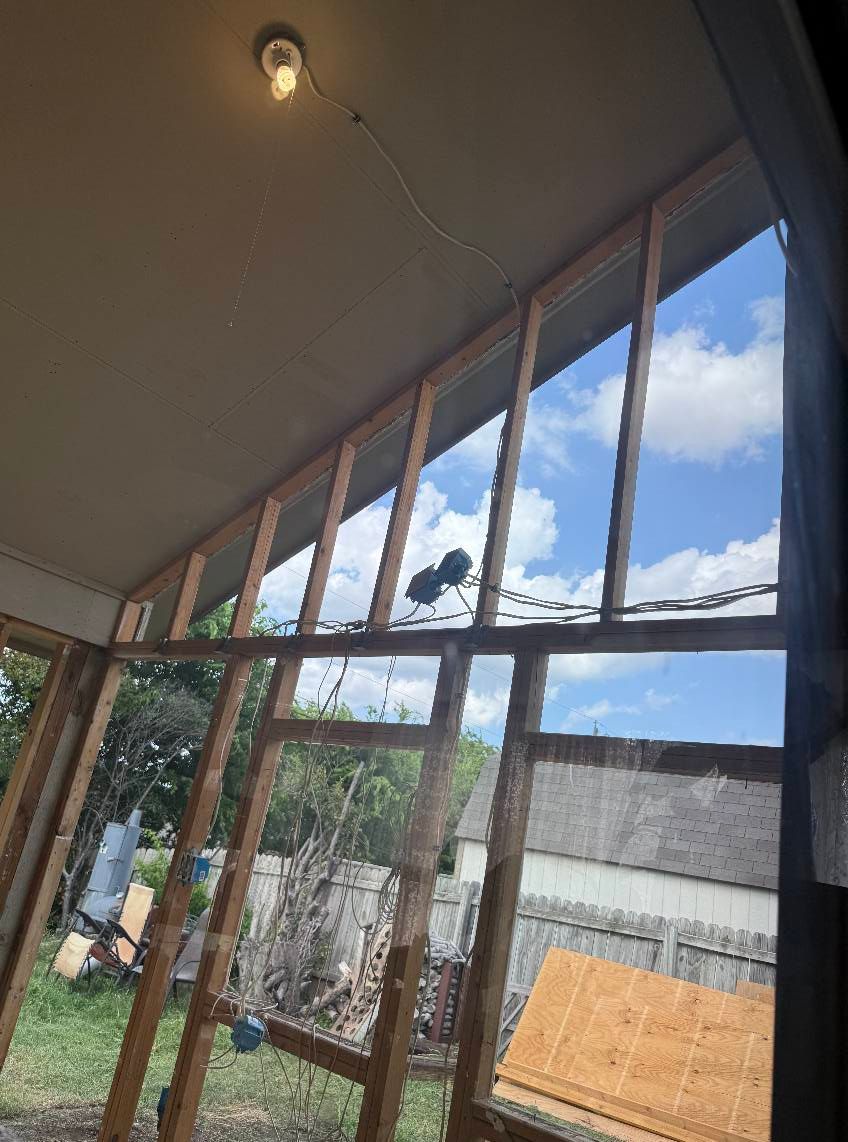 A room with a lot of windows and a light on the ceiling.