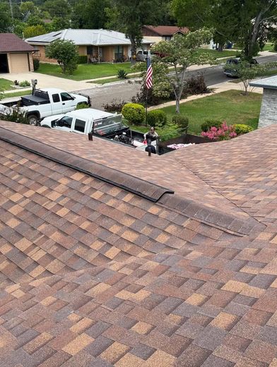 A roof with a lot of shingles on it in a residential area.