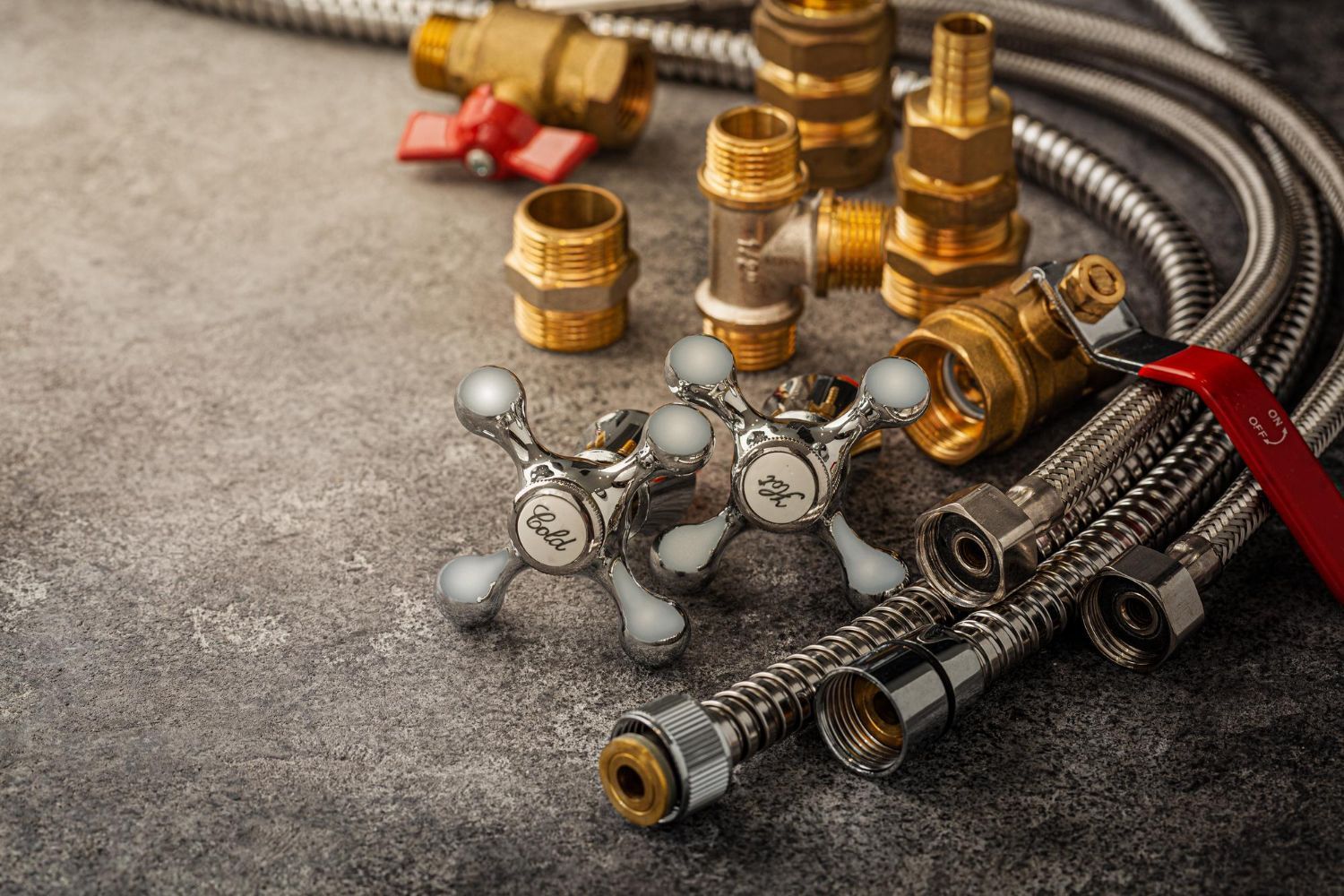 There are many different types of plumbing parts on the table.