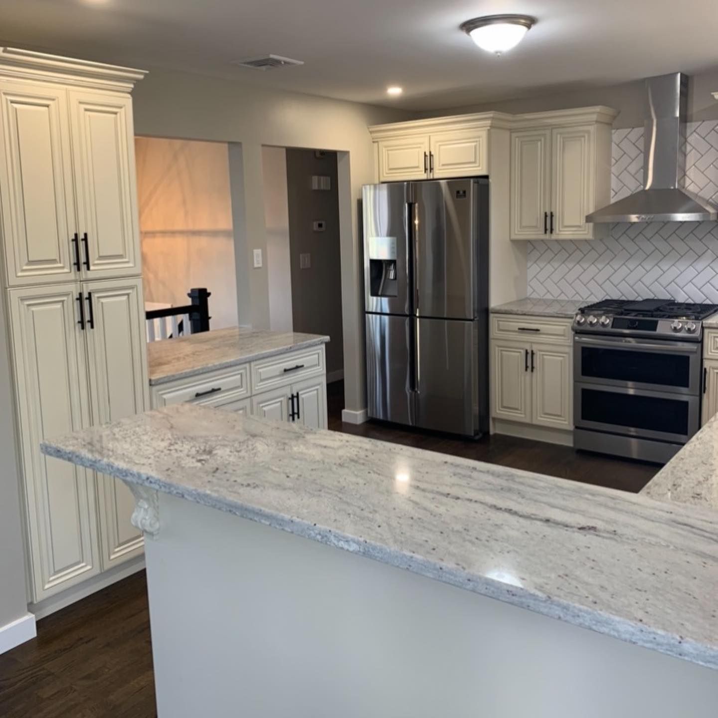 A kitchen with stainless steel appliances and white cabinets
